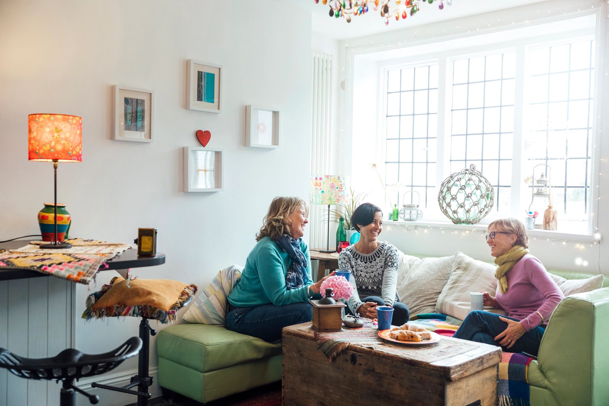 Two women talking comfortably together in a living room